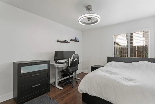 a bedroom with a bed and a desk