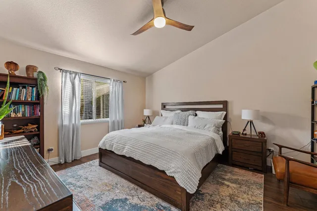 a bedroom with a bed and a book shelf
