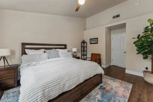 a bedroom with a bed and a potted plant