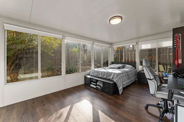 a bedroom with a bed and large window