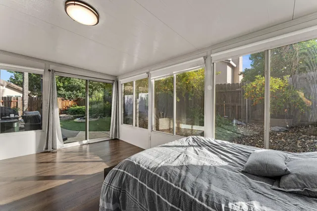 a bedroom with a large bed and a large window