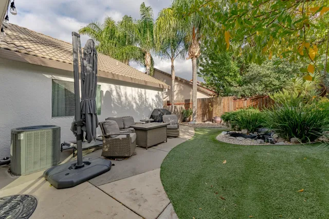 a view of a patio with couches table and chairs and potted plants