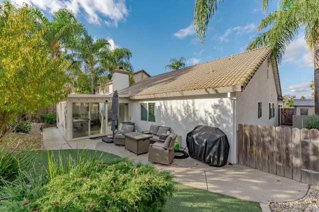 a view of a patio with table and chairs potted plants with wooden fence
