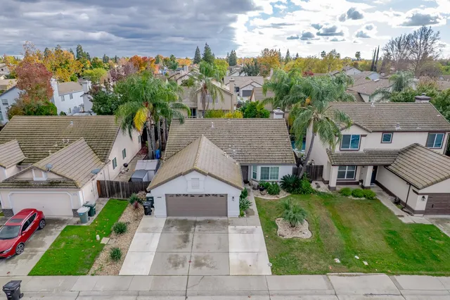 an aerial view of a house with a yard