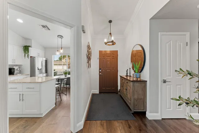 a view of hallway with wooden floor