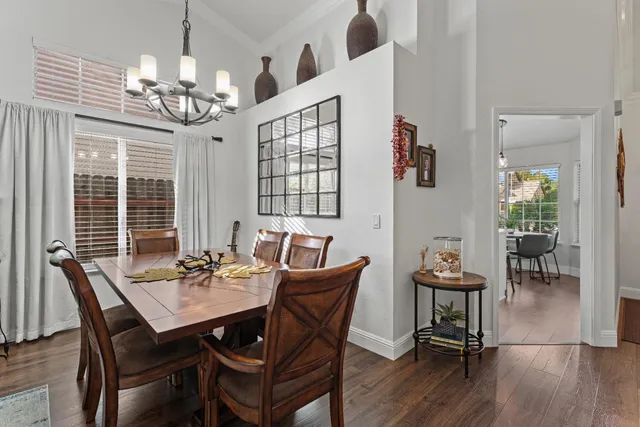 a view of a dining room with furniture wooden floor and chandelier