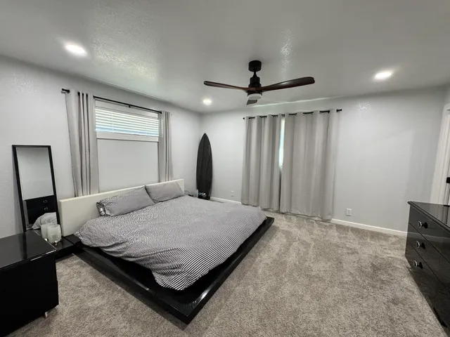 a bed room with a bed and a television