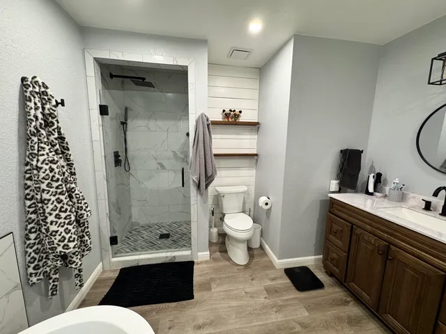 a bathroom with a sink toilet and shower