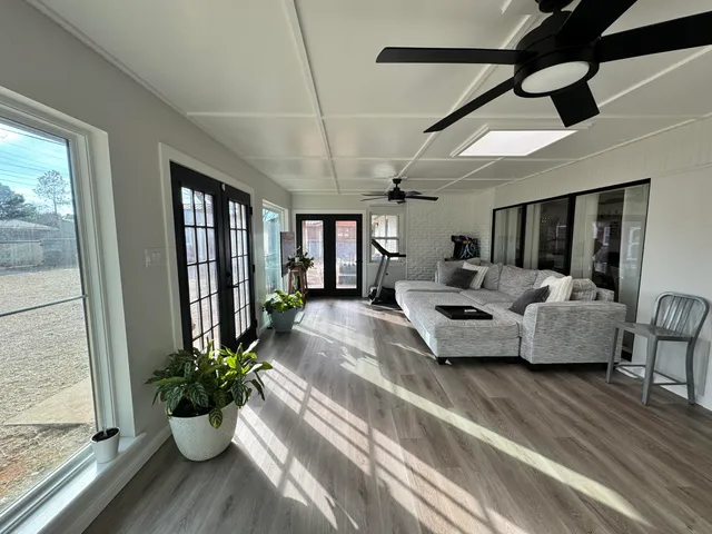 a living room with furniture and a potted plant