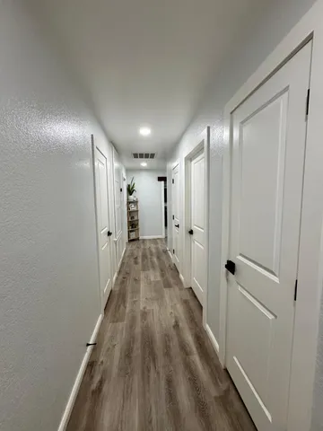a view of hallway with wooden floor