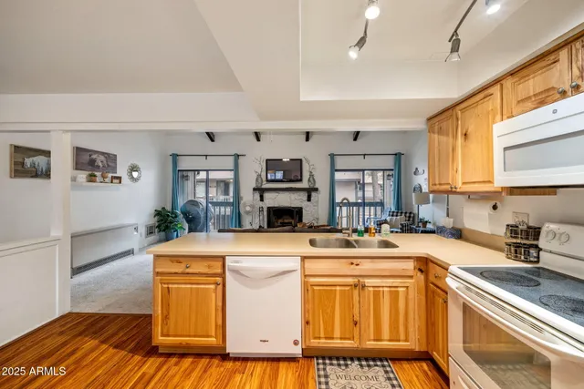 a kitchen with cabinets appliances and a counter space