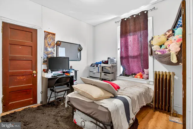 a bedroom with a bed and a tv