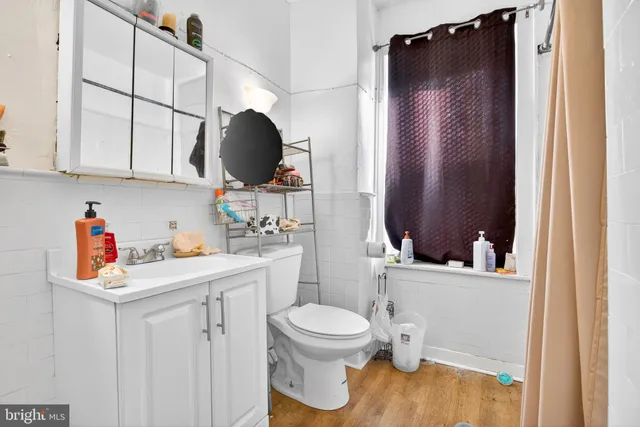 a bathroom with a sink toilet and a mirror