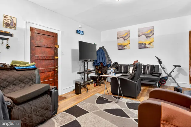 a living room with furniture a rug and a flat screen tv