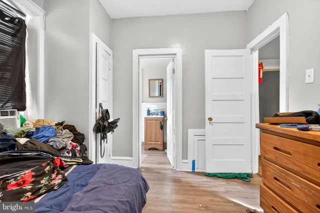 a view of a room that has a bed and a flat tv screen on the table