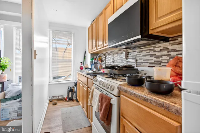 a kitchen with a stove and a refrigerator