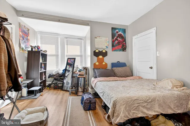 a bedroom with bed and a flat tv screen