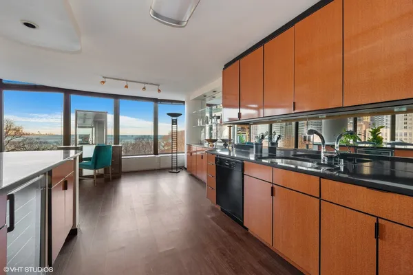 a open kitchen with stainless steel appliances granite countertop sink stove and wooden cabinets