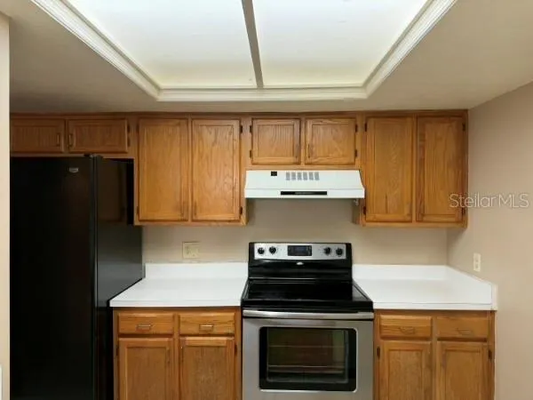 a kitchen with a stove and a refrigerator