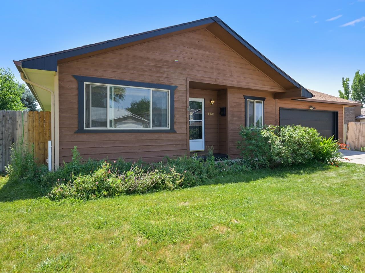 160 Sunset Drive Fruita, CO 81521 - Photo 1 of 22 a front view of a house with garden