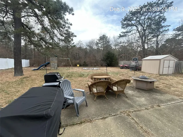 a view of a patio with a dining table and chairs with a fire pit
