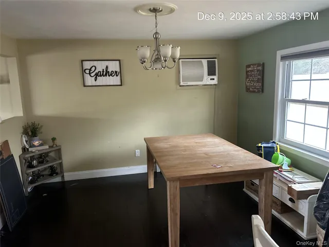 a dining room with a table chairs and chandelier