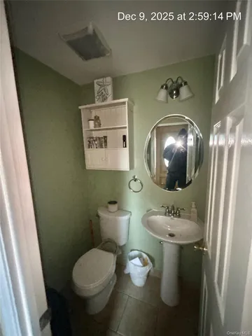 a bathroom with a toilet sink and mirror