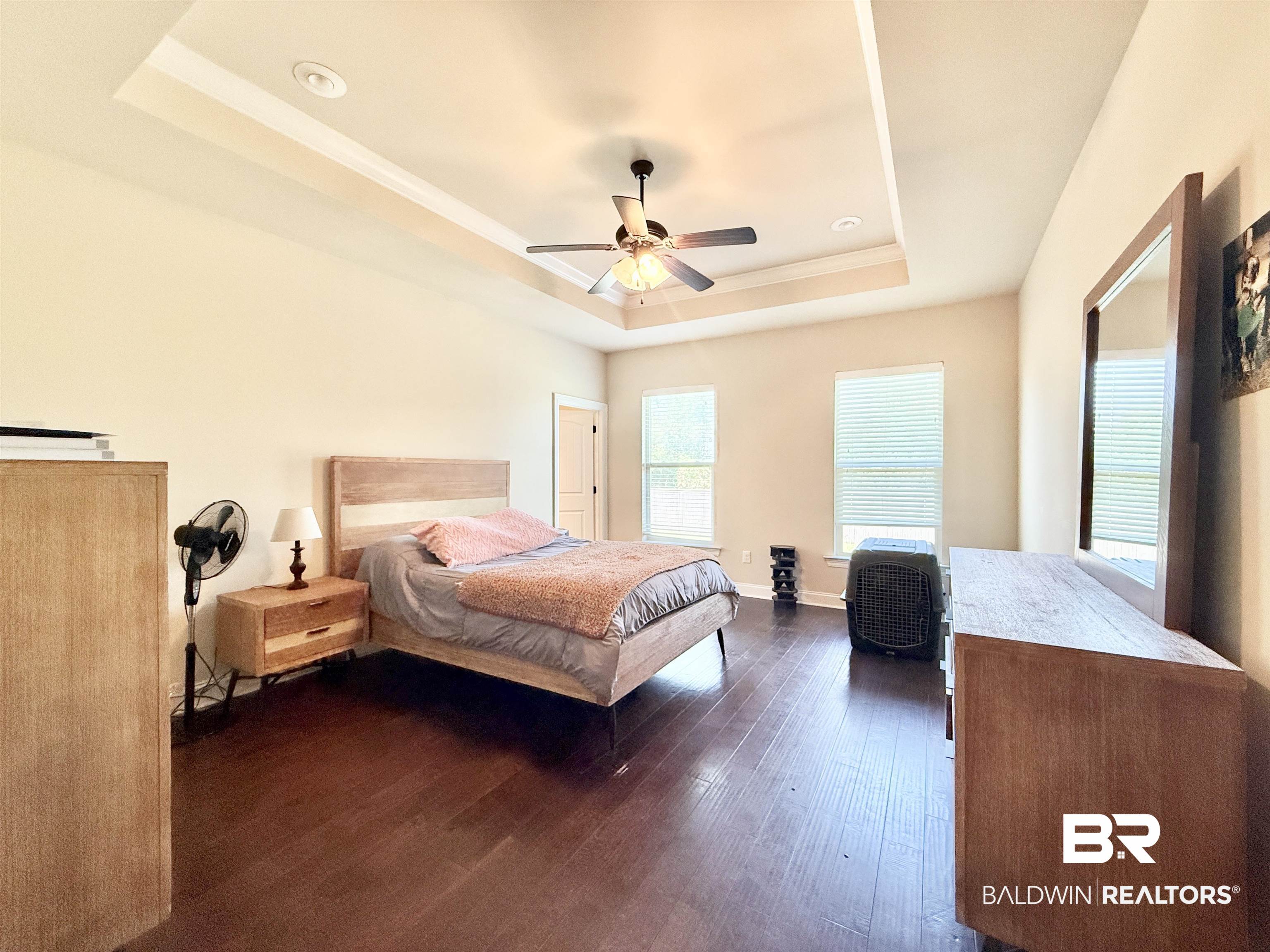 7011 Rocky Rd Loop Gulf Shores, AL 36542 - Photo 22 of 66 Bedroom with a tray ceiling, dark wood-style flooring, and a ceiling fan