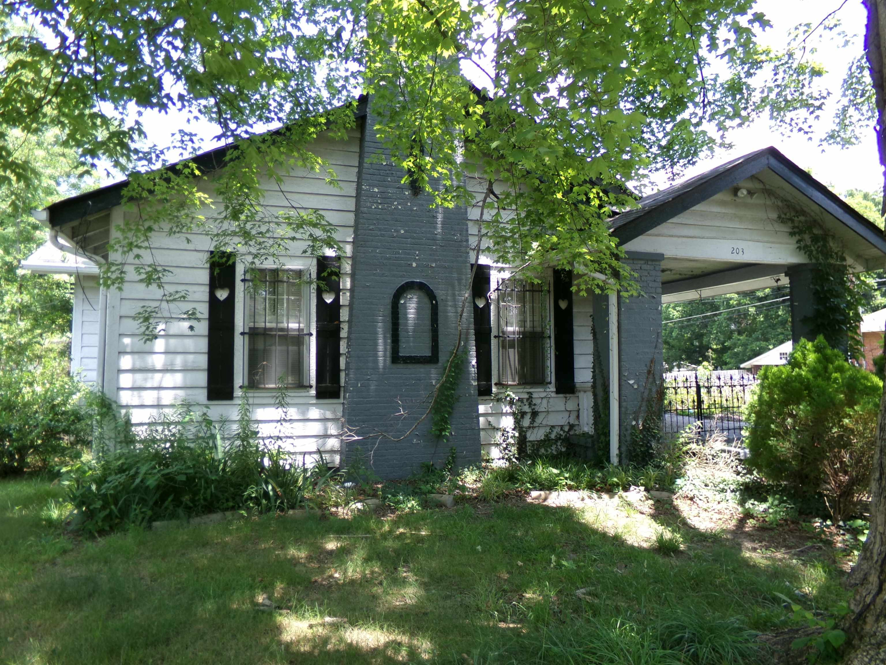 203 Division Avenue Jackson, TN 38301 - Photo 1 of 8 a front view of a house with a yard