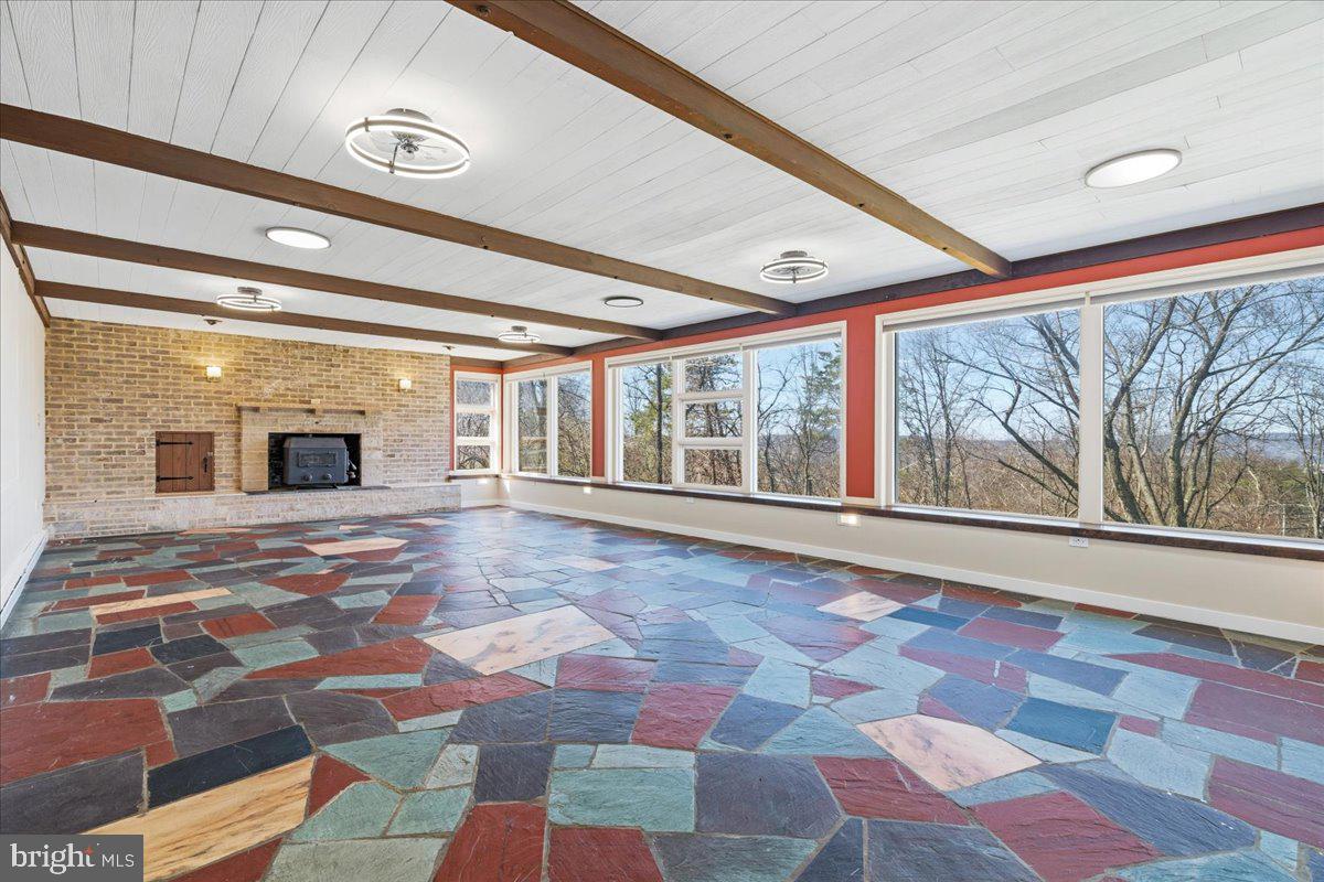 4835 Shookstown Road Frederick, MD 21702 - Photo 3 of 40 a view of an empty room with a rug and a floor to ceiling window