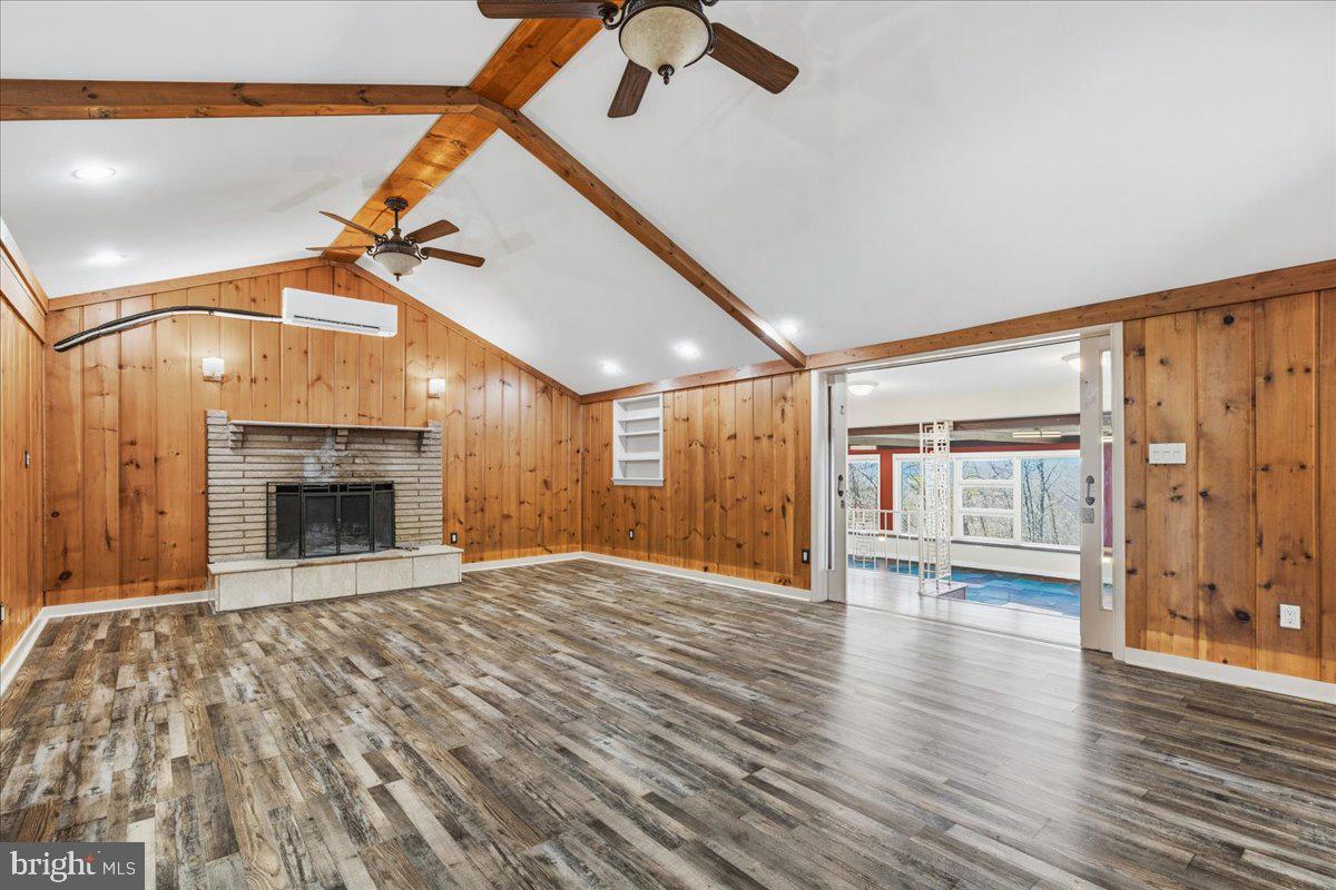 4835 Shookstown Road Frederick, MD 21702 - Photo 9 of 40 a view of an empty room with wooden floor fireplace and a window