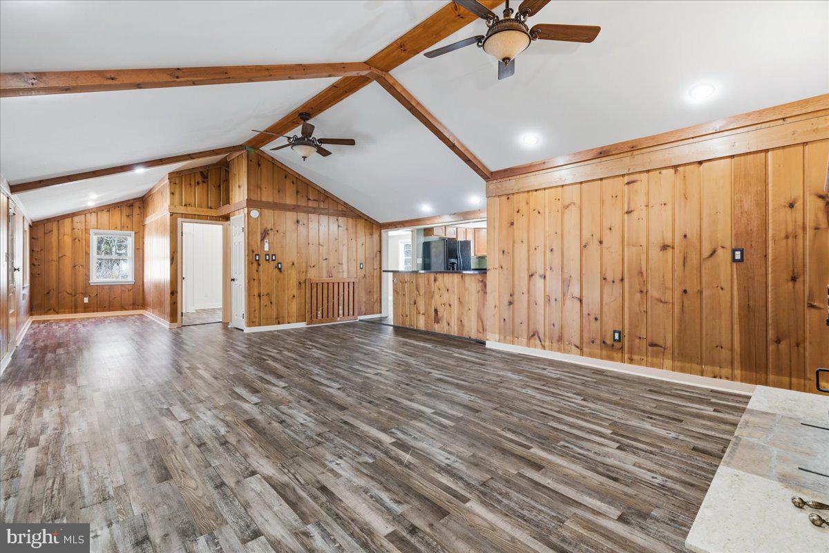4835 Shookstown Road Frederick, MD 21702 - Photo 10 of 40 a view of a livingroom with wooden floor and a ceiling fan