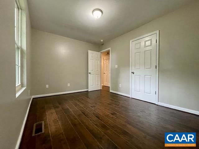 490 Jonquil Road Ruckersville, VA 22968 - Photo 12 of 18 an empty room with wooden floor and window