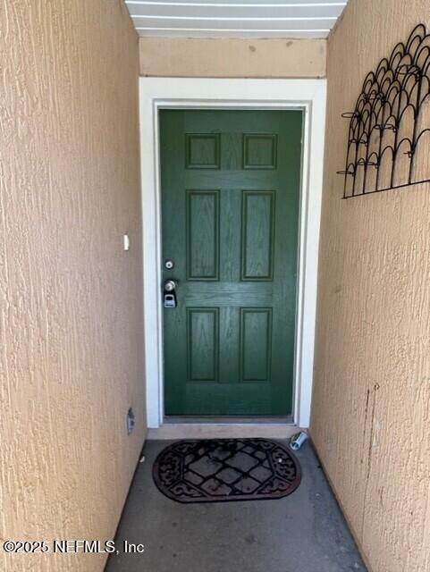 950 Wynfield Circle St. Augustine, FL 32092 - Photo 3 of 30 a view of a utility room with a fireplace and green walls