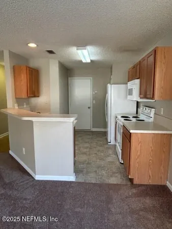 a white refrigerator freezer sitting in a kitchen