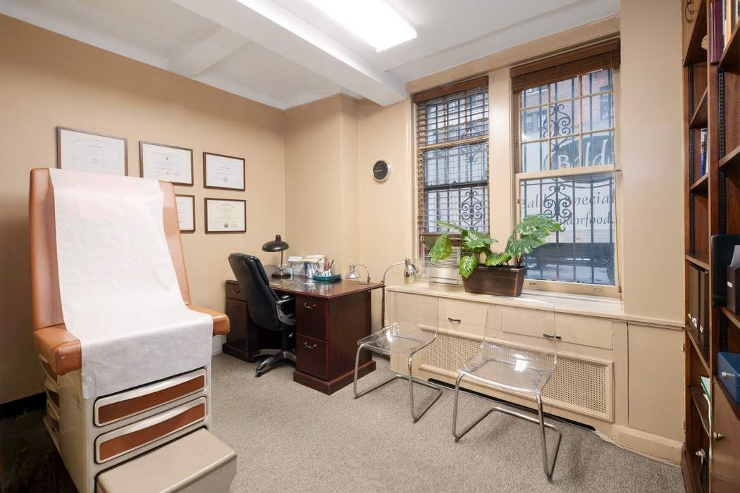 116 East 63rd Street, Unit 1A Manhattan, NY 10065 - Photo 5 of 11 a living room with furniture and a window