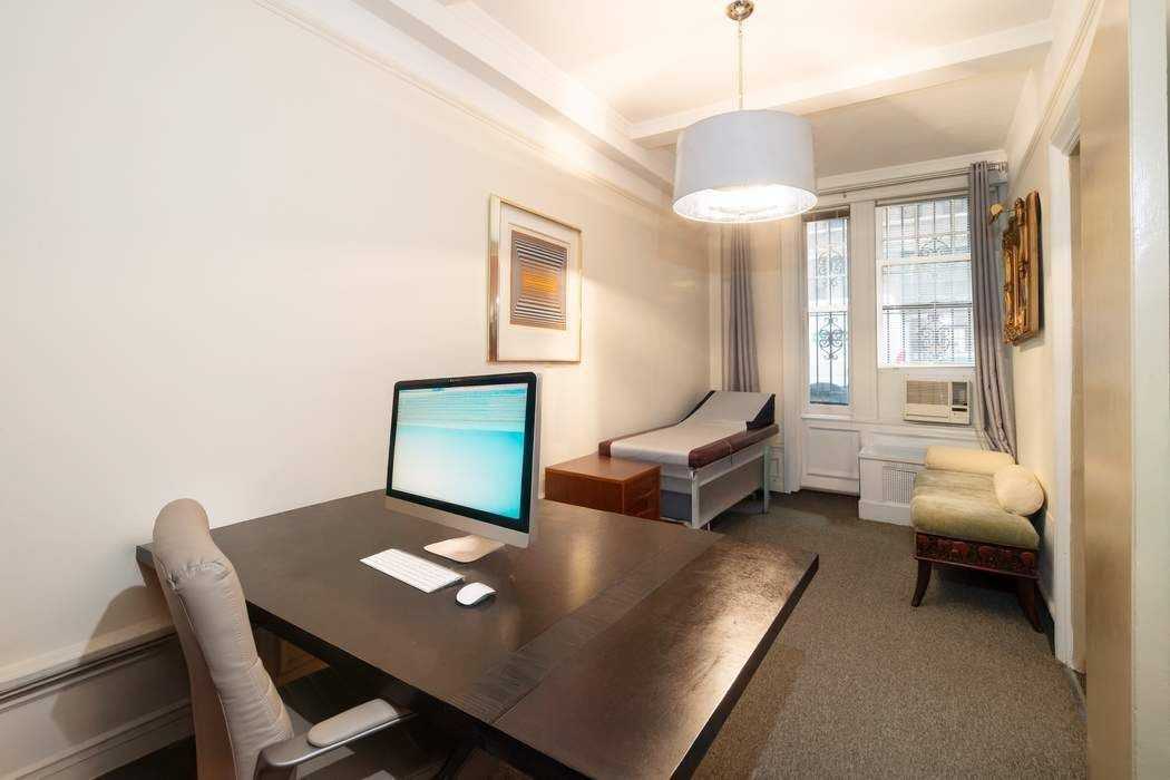 116 East 63rd Street, Unit 1A Manhattan, NY 10065 - Photo 7 of 11 a workspace with furniture and a window