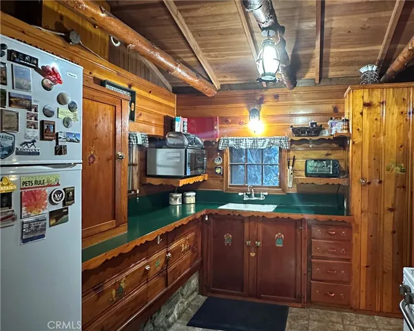 a kitchen with stainless steel appliances granite countertop a refrigerator and a stove