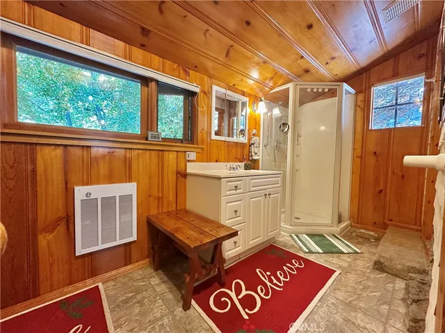 a view of house with yard outdoor seating and covered with trees
