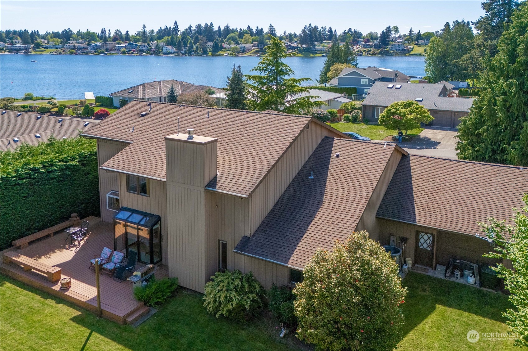 an aerial view of a house with outdoor space and lake view