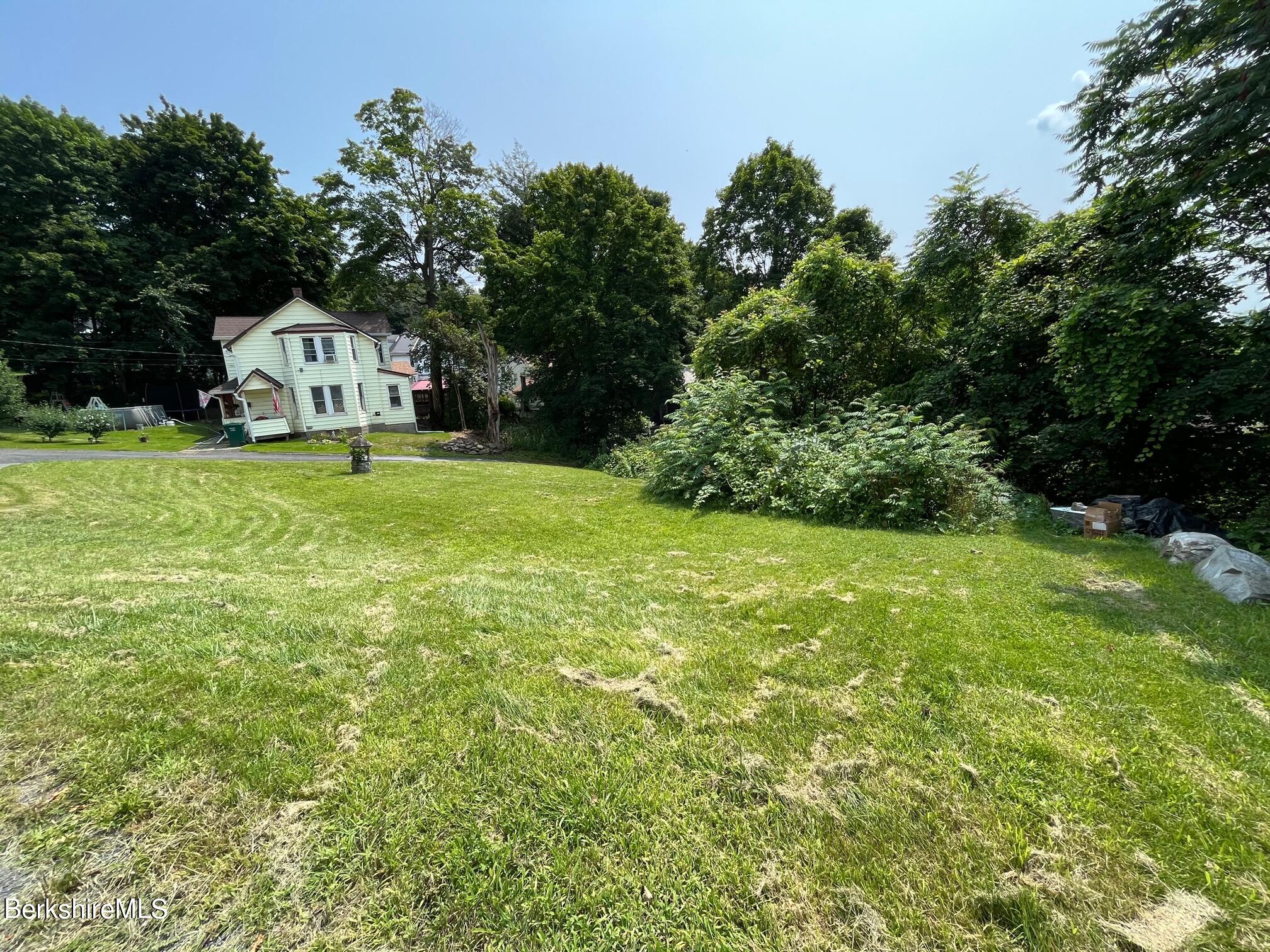 21 Ray Street North Adams, MA 01247 - Photo 4 of 27 a view of a house with a big yard and large trees