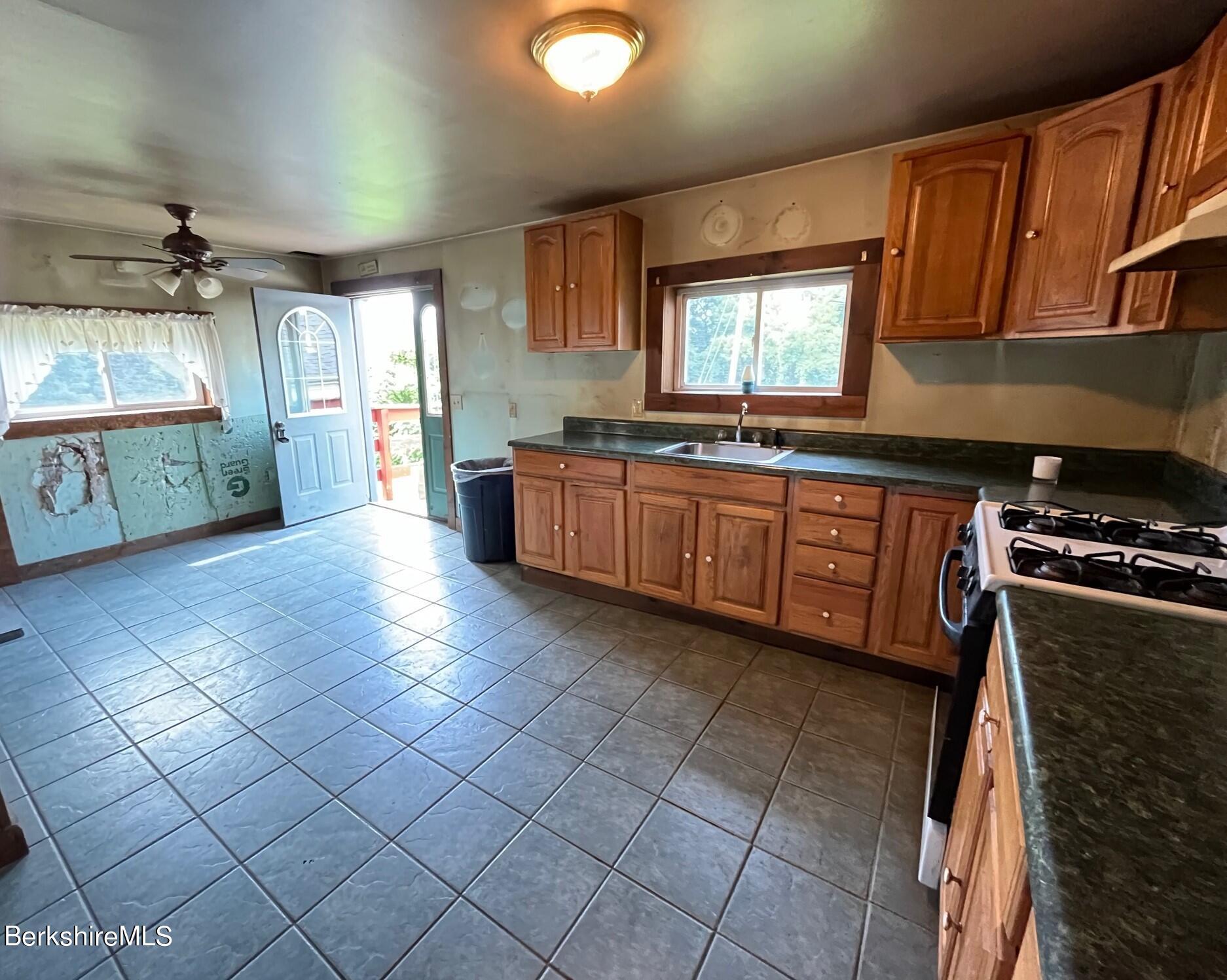 21 Ray Street North Adams, MA 01247 - Photo 7 of 27 a large kitchen with stainless steel appliances granite countertop a sink and cabinets