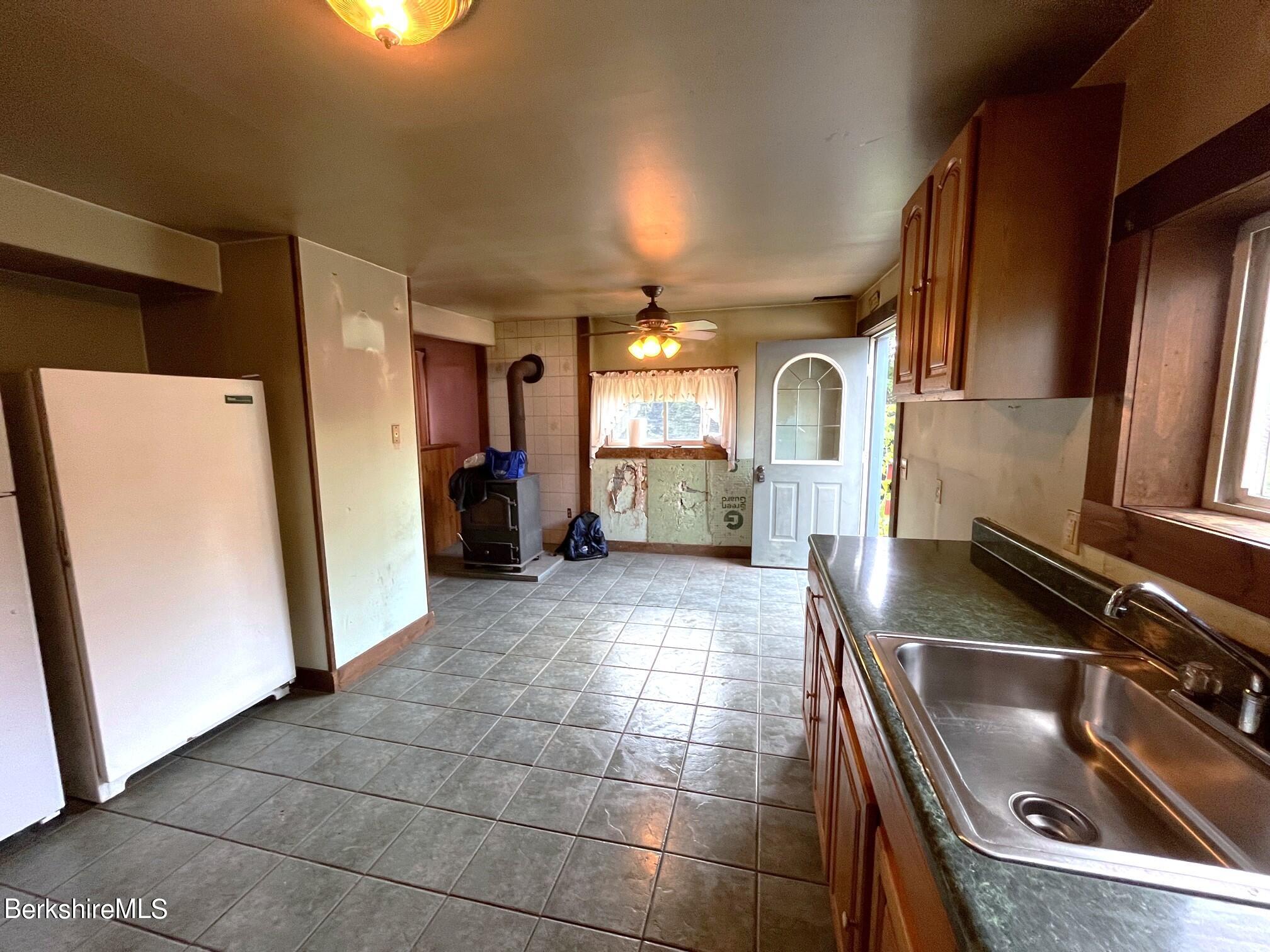 21 Ray Street North Adams, MA 01247 - Photo 8 of 27 a kitchen with a sink refrigerator and cabinets