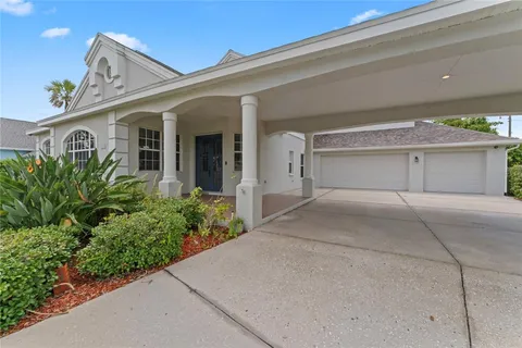 a view of a white house with a yard