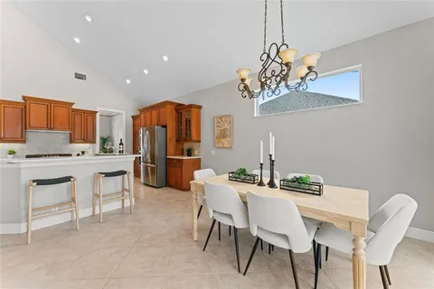 a living room with furniture a rug and a chandelier