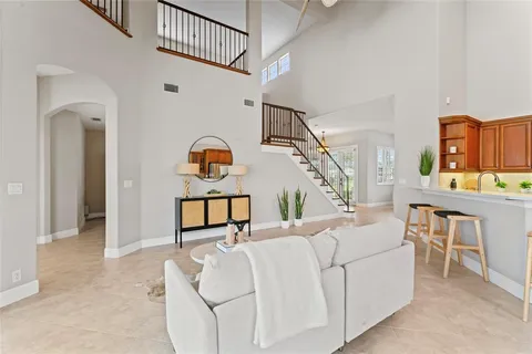 a room with chandelier fan and a wooden floor