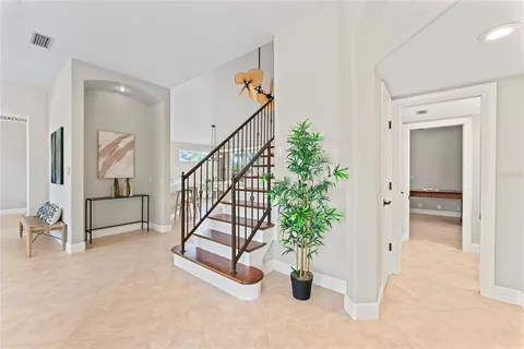 wooden floor with white walls and stairs