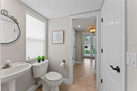 a spacious bedroom with a bed and a chandelier