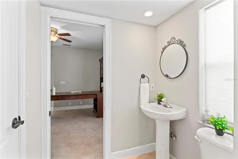 a bathroom with a sink vanity mirror and toilet