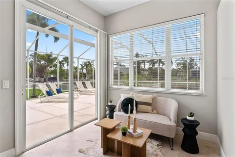 an empty room with windows and ceiling fan